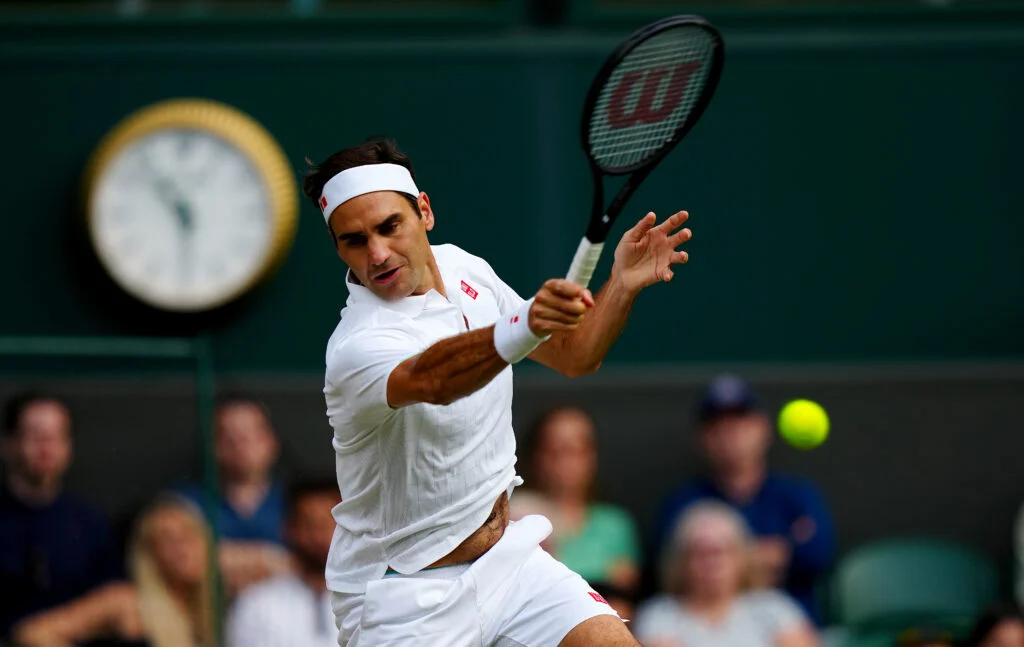 Roger Federer hits a forehand at Wimbledon in 2021.