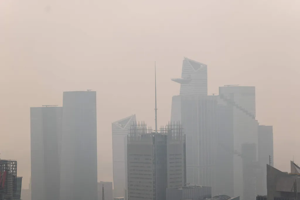 NEW YORK, NEW YORK - JULY 16: Haze from Canadian wildfires blankets the Manhattan skyline as seen from the Top of the Rock Observation Deck on July 16, 2026 in New York City. Much of the East Coast and Canada is under an Air Quality Health Advisory as the Canadian and Great Lakes wildfire smoke gradually moves through the area, creating a thick haze in the heat. The region is experiencing temperatures with heat indexes over 100 degrees as it confronts another heat wave. Spencer Platt/Getty Images/AFP (Photo by SPENCER PLATT / GETTY IMAGES NORTH AMERICA / Getty Images via AFP)