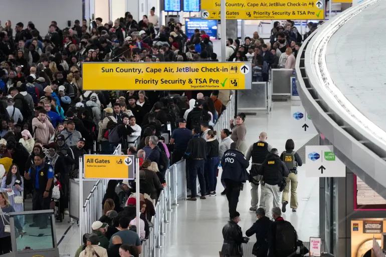 Immigration and Customs Enforcement (ICE) agents patrol at John F. Kennedy International Airport, New York City, U.S. March 23, 2026. Hundreds of Immigration and Customs Enforcement agents were ordered to deploy to airports to help fill TSA staffing gaps across the country. REUTERS/Adam Gray